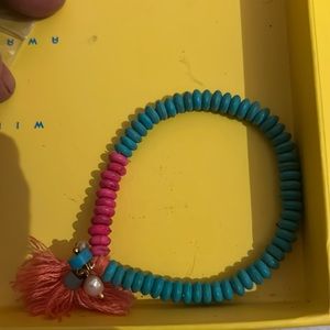 Orange cloth dangle with pink and blue beaded bracelet